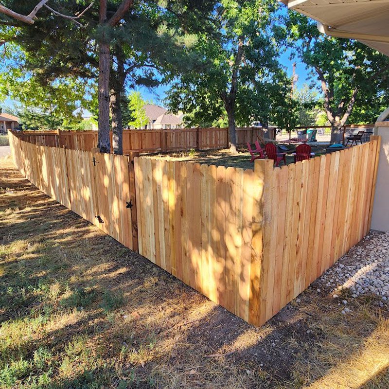 stockade wood fence in front range