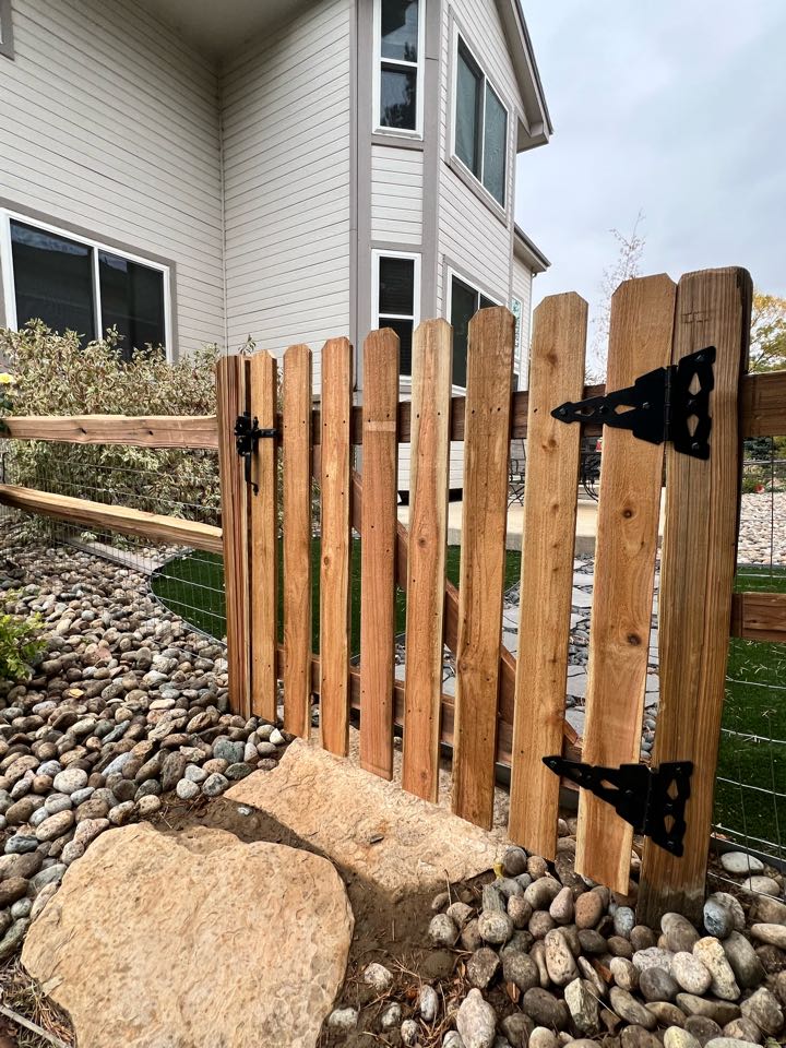 This is a 3 1/2 foot high two rail split rail fence with welded wire and one single swing gate. The fence and gate are constructed to meet the HOA regulations in a golf course community in Thornton, Colorado.