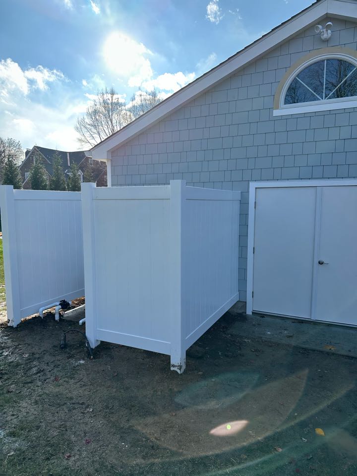 Crew hard at work despite the cold! A new 3-rail aluminum fence going in around the pool, with a vinyl privacy fence for the pool equipment. 