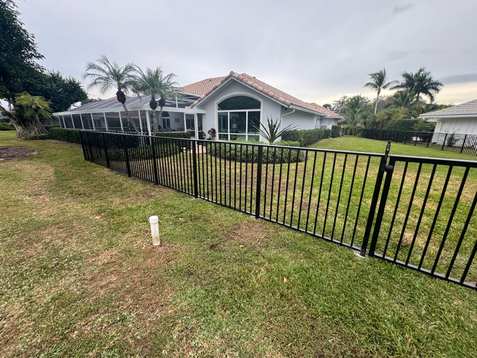In PGA National of Palm Beach Gardens, FL, we installed nearly 200 feet of 4-foot-tall smooth-top black aluminum fencing with two gates to help a homeowner keep their three dogs safe. We also took care of the HOA application and managed the entire permit process, making the project hassle-free for the customer. At Top Rail Fence, we deliver secure, stylish solutions while handling the details so you don’t have to.