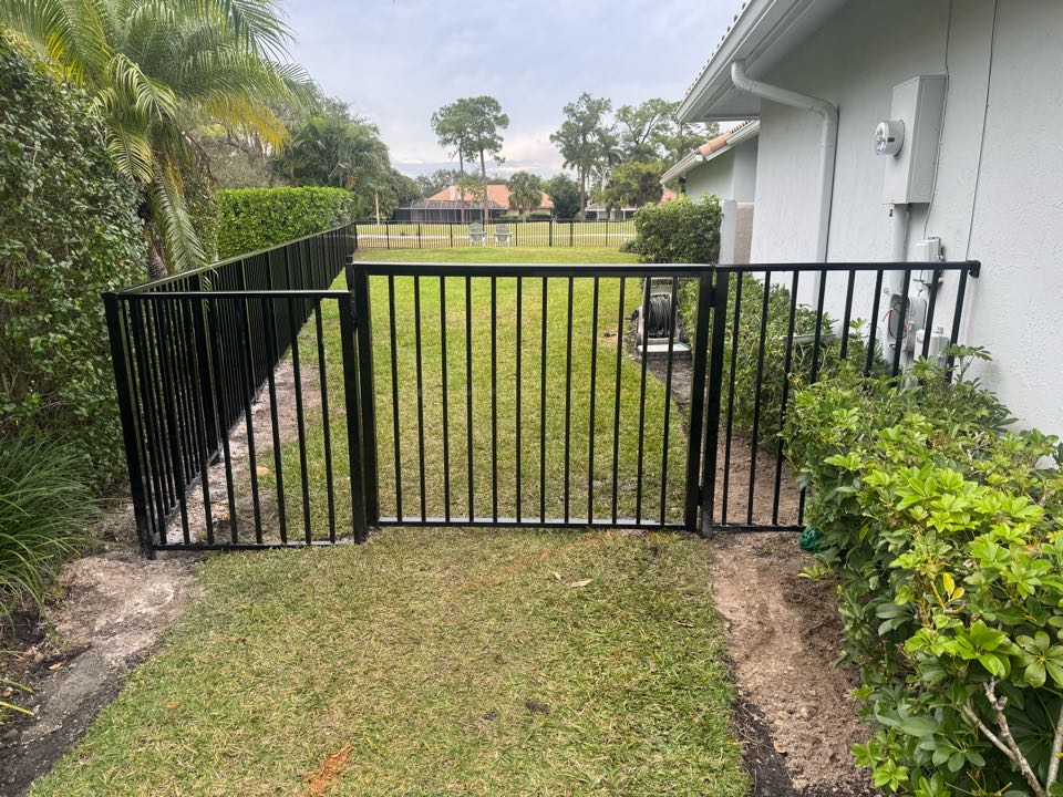 In PGA National of Palm Beach Gardens, FL, we installed nearly 200 feet of 4-foot-tall smooth-top black aluminum fencing with two gates to help a homeowner keep their three dogs safe. We also took care of the HOA application and managed the entire permit process, making the project hassle-free for the customer. At Top Rail Fence, we deliver secure, stylish solutions while handling the details so you don’t have to.