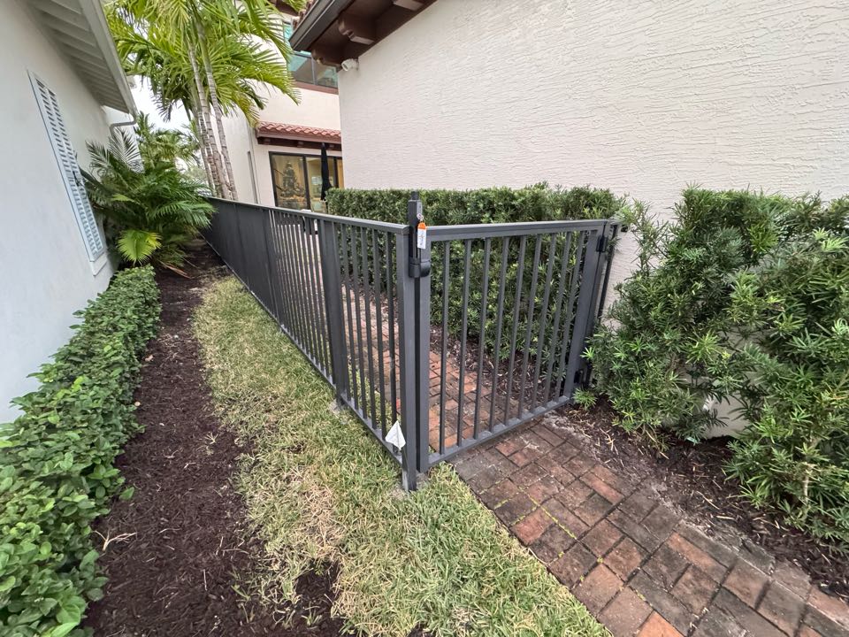 In the Alton community of Palm Beach Gardens, FL, we installed 70 feet of 4-foot-tall bronze smooth-top aluminum fencing with two gates featuring key lock entry. This project created a safe, secure space for a family with two kids and a dog, while we handled the HOA application and permit process from start to finish. 