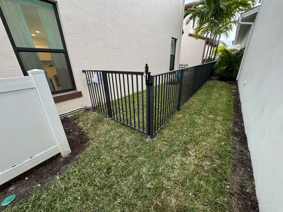 In the Alton community of Palm Beach Gardens, FL, we installed 70 feet of 4-foot-tall bronze smooth-top aluminum fencing with two gates featuring key lock entry. This project created a safe, secure space for a family with two kids and a dog, while we handled the HOA application and permit process from start to finish. 