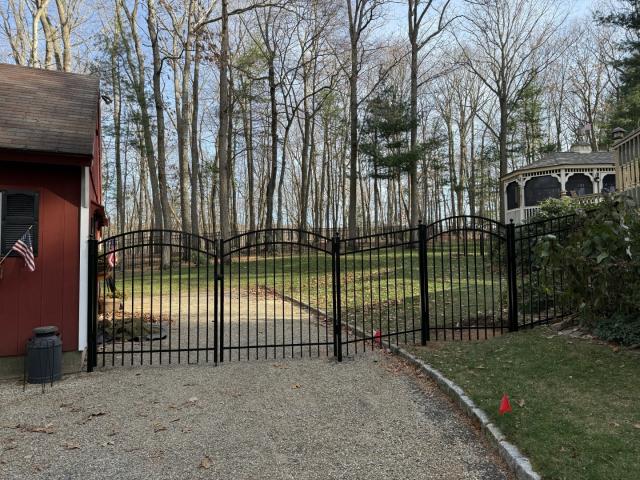 Install team complete a five-foot-tall black ornamental aluminum fence with three double accent gates and one single accent gate.