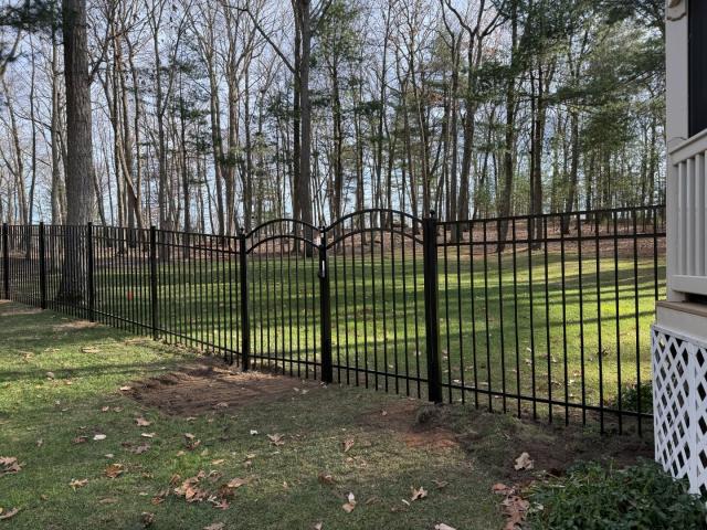 Install team complete a five-foot-tall black ornamental aluminum fence with three double accent gates and one single accent gate.