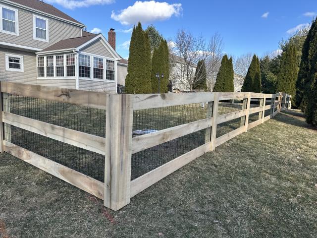 
We installed a 176-foot-long 4-foot-high wood 3-rail fence with black welded wire and 2 gates. 