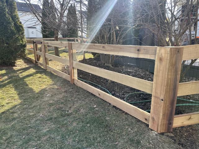 
We installed a 176-foot-long 4-foot-high wood 3-rail fence with black welded wire and 2 gates. 