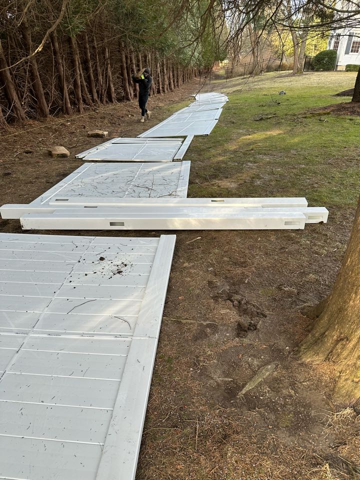 Guys getting started on a new white vinyl privacy fence in Darien!