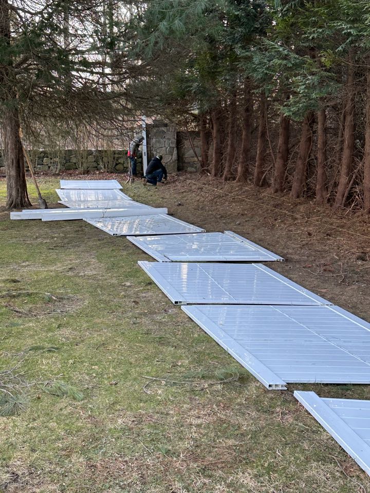 Guys getting started on a new white vinyl privacy fence in Darien!