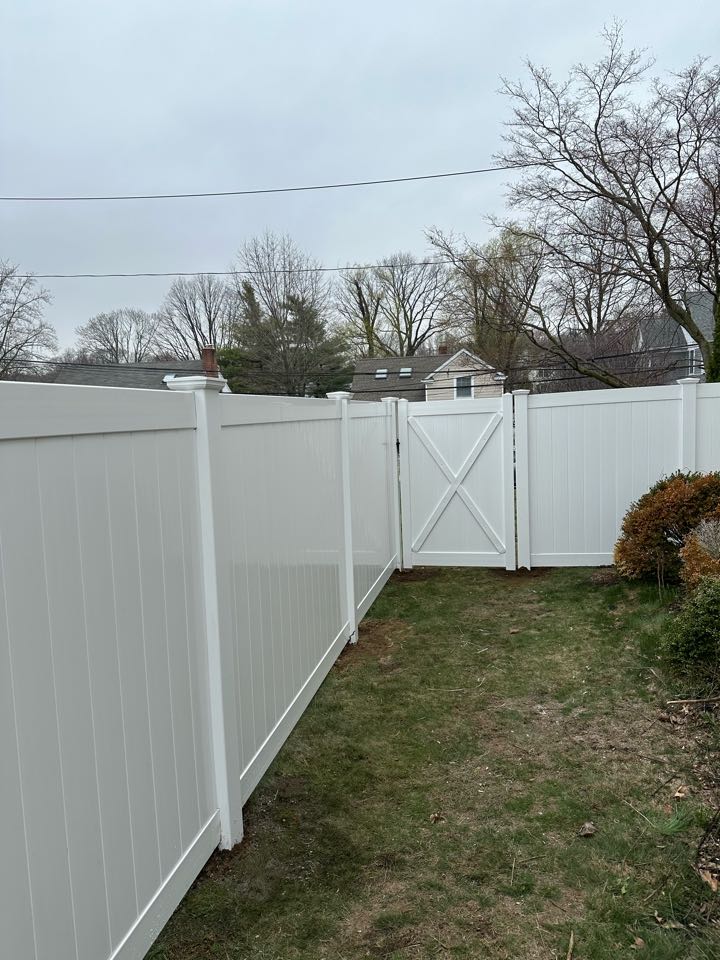 Wrapping up a new white vinyl privacy fence in Darien! Dogs are happy and safe inside a new, larger back yard!