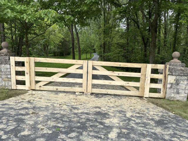 117 feet of 4’ high poplar 4 rail fence installed with a double swing driveway gate. 