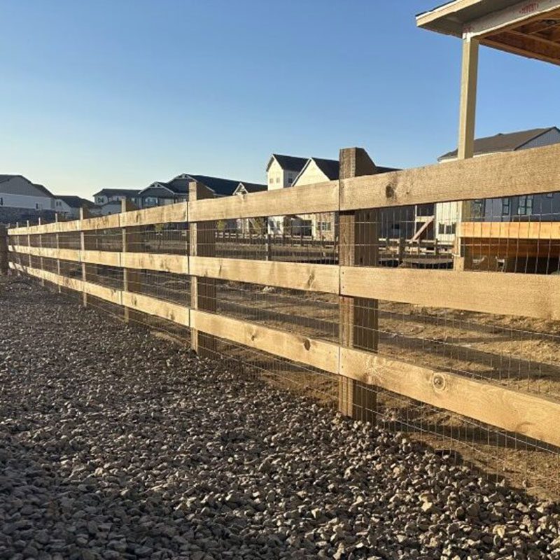 wood post and rail fence with chicken wire