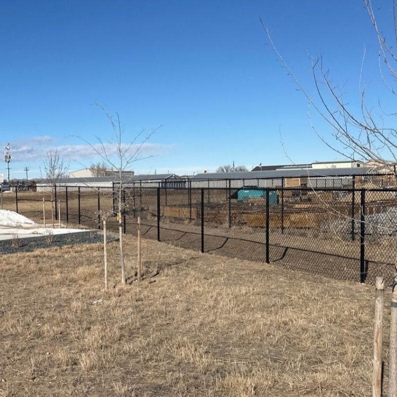 black chain link commercial fence installed by Top Rail Fence