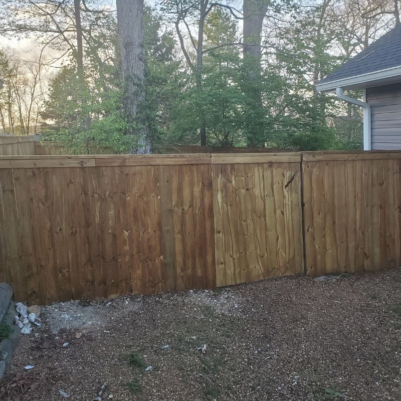 pressure-treated pine privacy fence in a Charleston cap-and-trim style