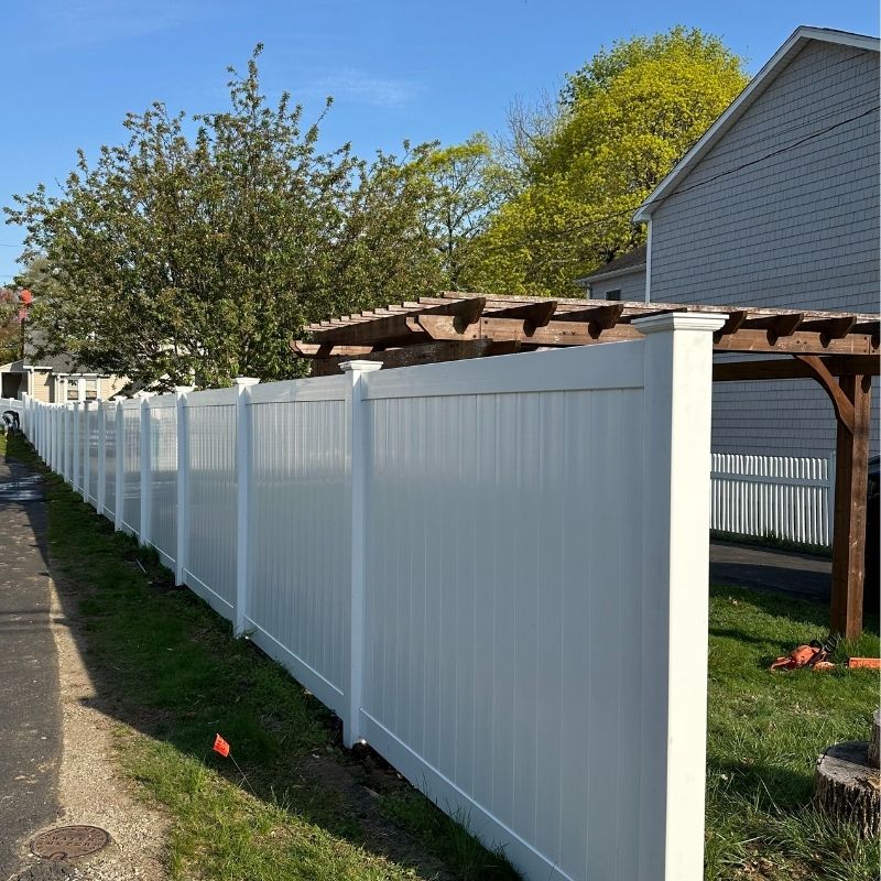 White vinyl privacy fence installed by Top Rail Fence