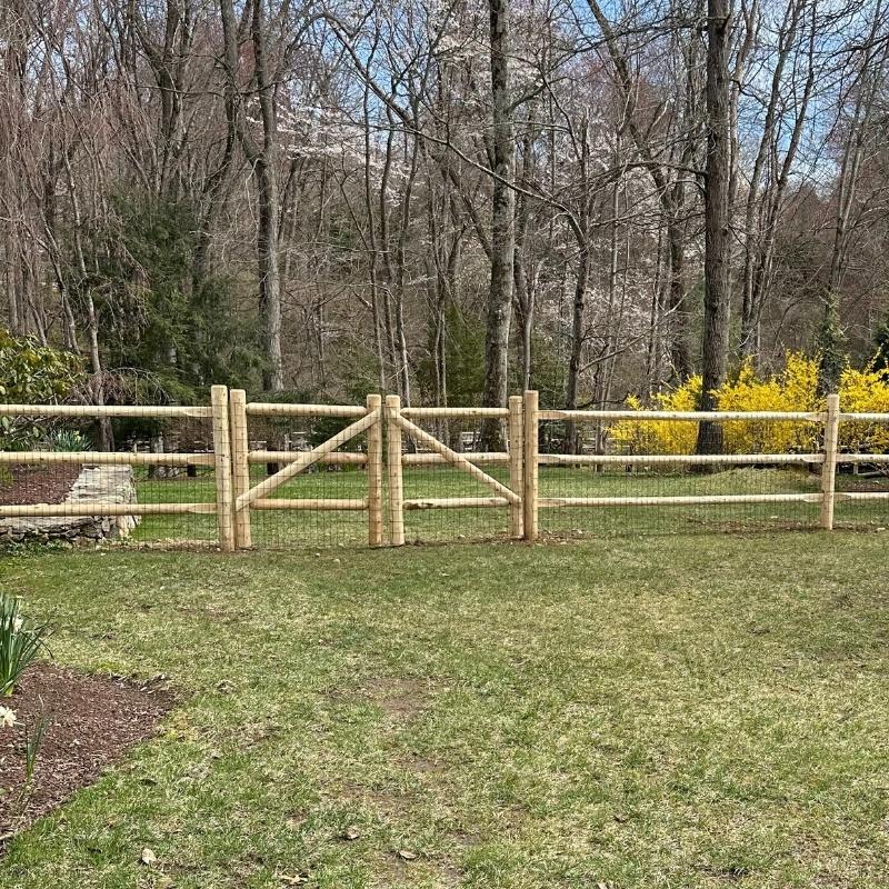 cedar round post and rail fence/gate with heavy duty welded wire installed by Top Rail Fence