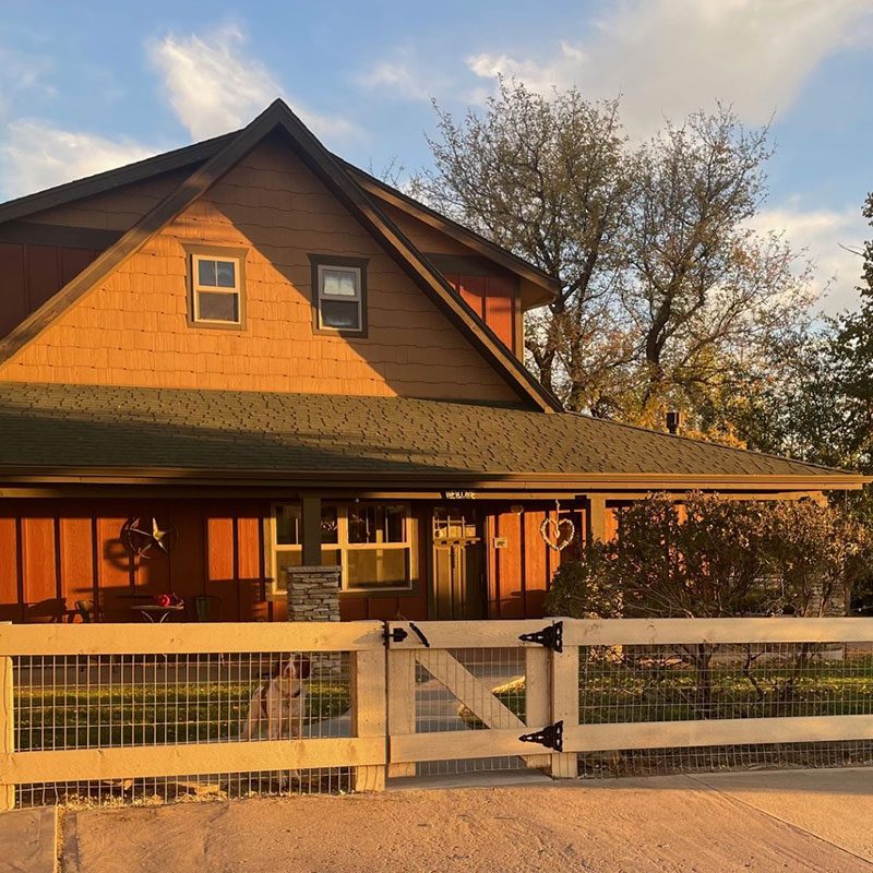 front view of post and rail fence with gate