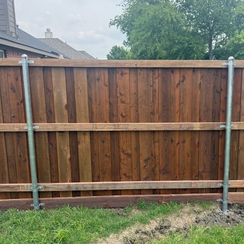 6-foot board-on-board fence with cap and trim installed by Top Rail Fence